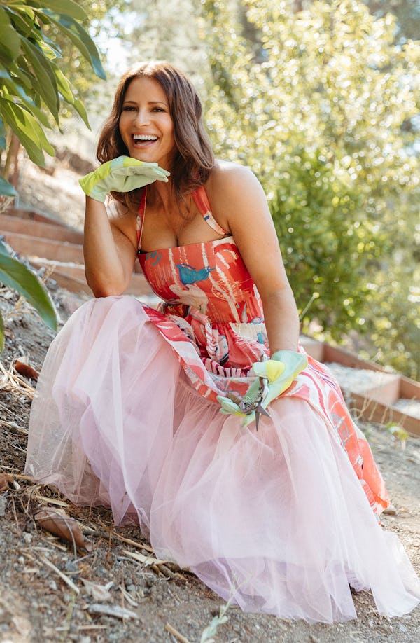 Andrea Savage Posing In A Pinkish-Orange Dress