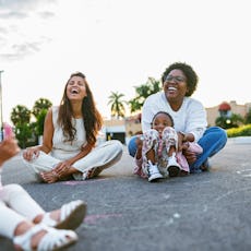 Mom friends hang out with their kids, laughing and enjoying each other.