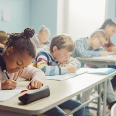 Elementary classroom of children taking a test