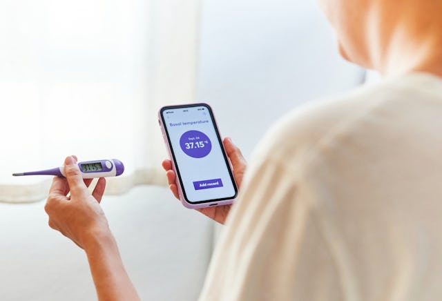 A woman tracks her basal body temperature, which is a good indicator for ovulation.