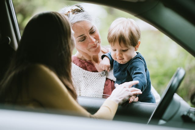 A woman drops her child off with the child's grandmother.