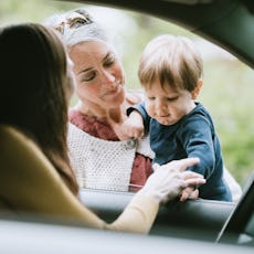 A woman drops her child off with the child's grandmother.