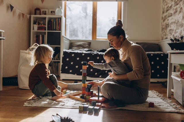 A mom plays with her kids.