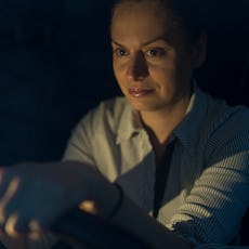 Mom out driving at night to pick her tween up from sports. 