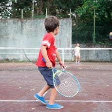 Boy playing tennis with his mother, Oleiros, A Coruna, Galicia, Spain