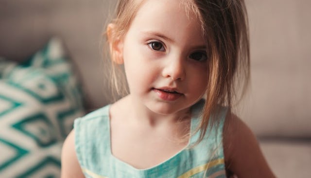 A little blonde girl in a light blue dress