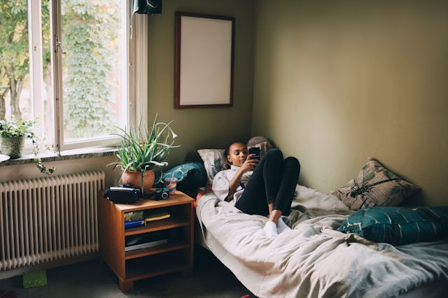 A teen girl relaxes in her bedroom.