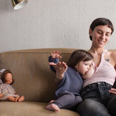 A mother breastfeeding a toddler. The AAP now recommends breastfeeding for two years or more.