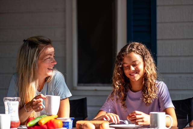 mom and daughter having breakfast on the terrace