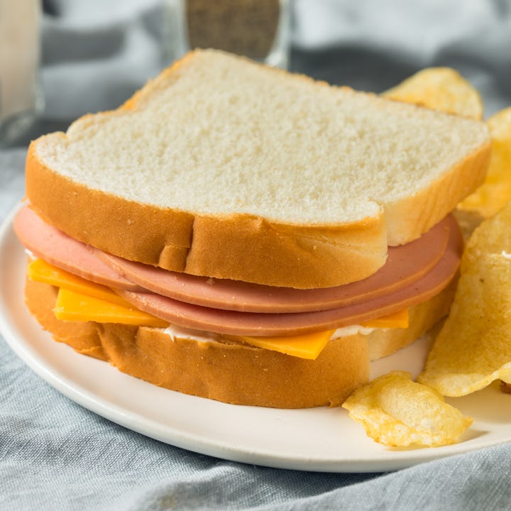 A bologna sandwich with chips.