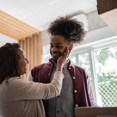 Mother and son embracing at home