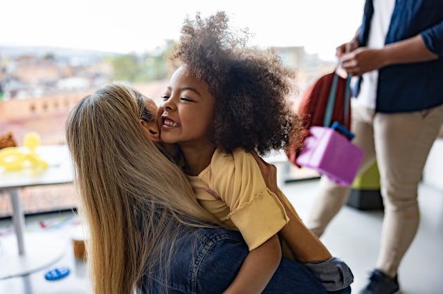 A young girl hugs her mom after being reunited.