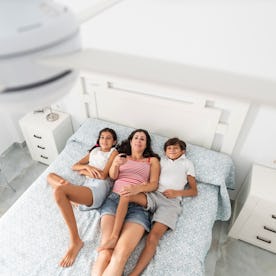 A mom and her kids change the ceiling fan direction.