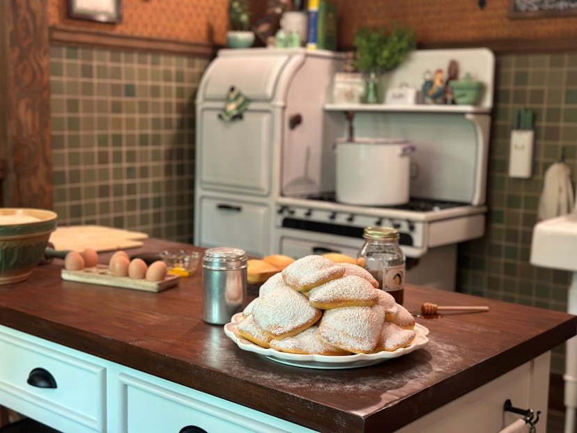 In the queue for Disney's new 'Tiana's Bayou Adventure' ride, guests see fresh beignets in Tiana's r...