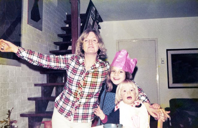 Mother with her two children celebrate Christmas at home.