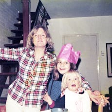 Mother with her two children celebrate Christmas at home.