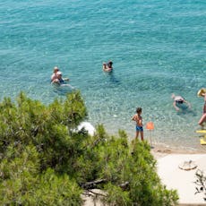 Sandy Beach and beach bar with sunbeds and umbrellas called Tortuga at Sithonia peninsula, Halkidiki...