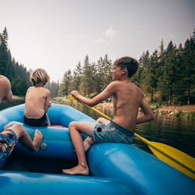 USA, California, Boys (8-9, 12-13) rafting on Truckee river