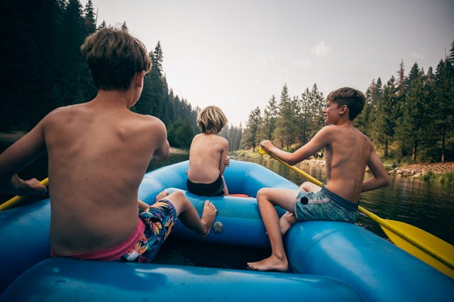 USA, California, Boys (8-9, 12-13) rafting on Truckee river