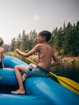 USA, California, Boys (8-9, 12-13) rafting on Truckee river