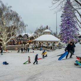 People enjoying a sledding hill in winter in downtown Leavenworth, Washington.