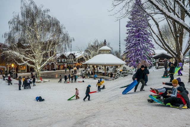 People enjoying a sledding hill in winter in downtown Leavenworth, Washington.